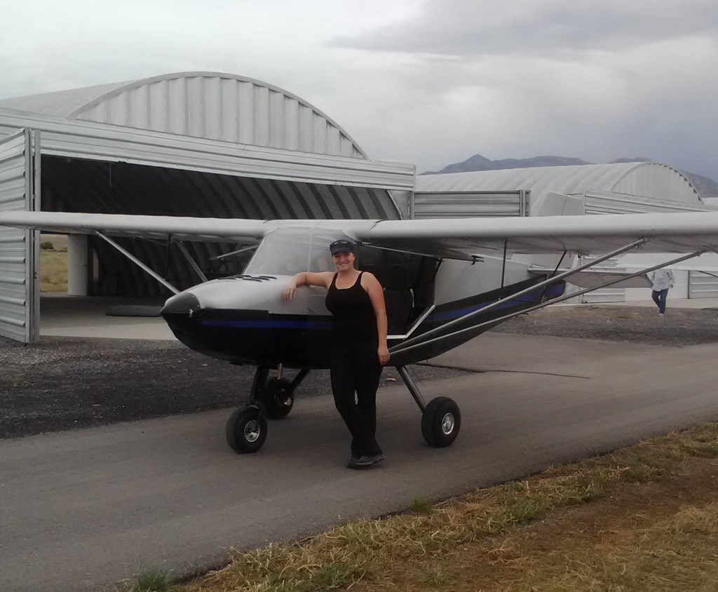 Julie posing with an airplane on the runway